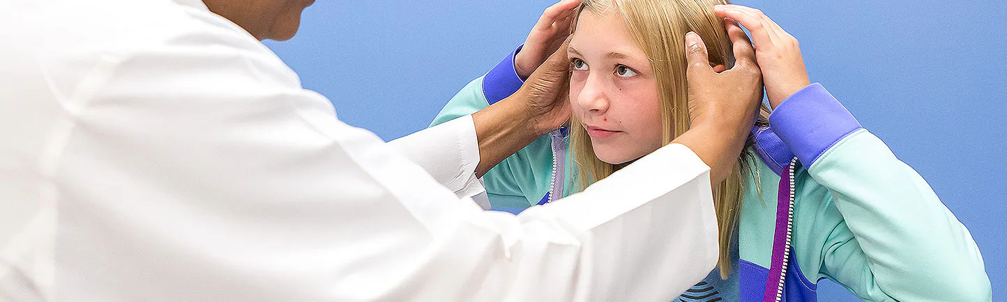 Nurse Jackie Miller examines a young patient