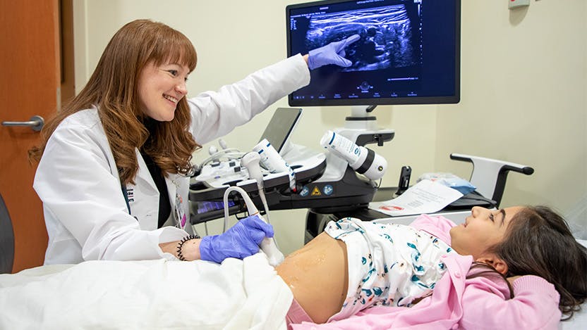 Dr. Amelia Kellar performing an intestinal ultrasound on a pediatric IBD patient