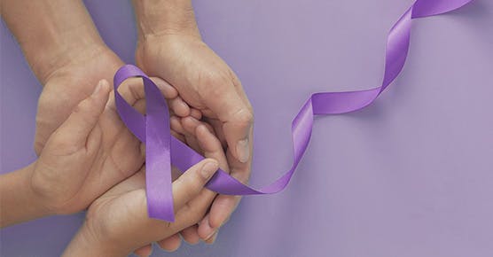 Image of child and parent holding pediatric lupus ribbon