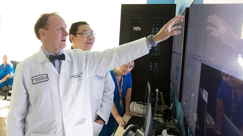 Pediatric neurologists Dr. Douglas Nordli and Dr. Chalongchai Phitsanuwong reviewing results on a screen