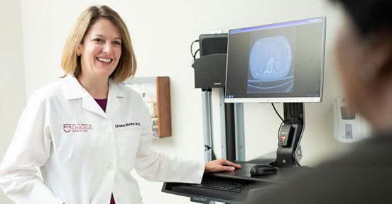 Olwen Hahn, MD, with CT scan and patient