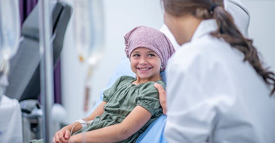 Image of physician talking to pediatric cancer patient