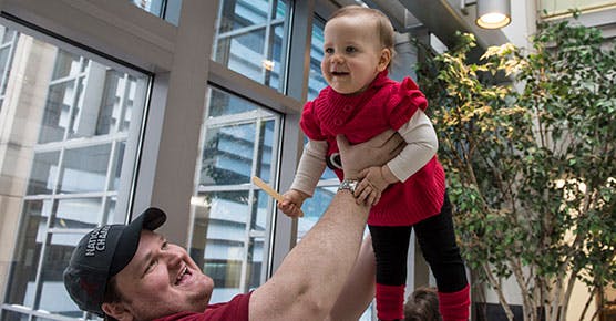 John Lawson plays with his daughter Molly, 15-months-old, following her visit with plastic and reconstructive surgeon Russell Reid, MD, PhD, at the Duchossois Center for Advanced Medicine (DCAM)